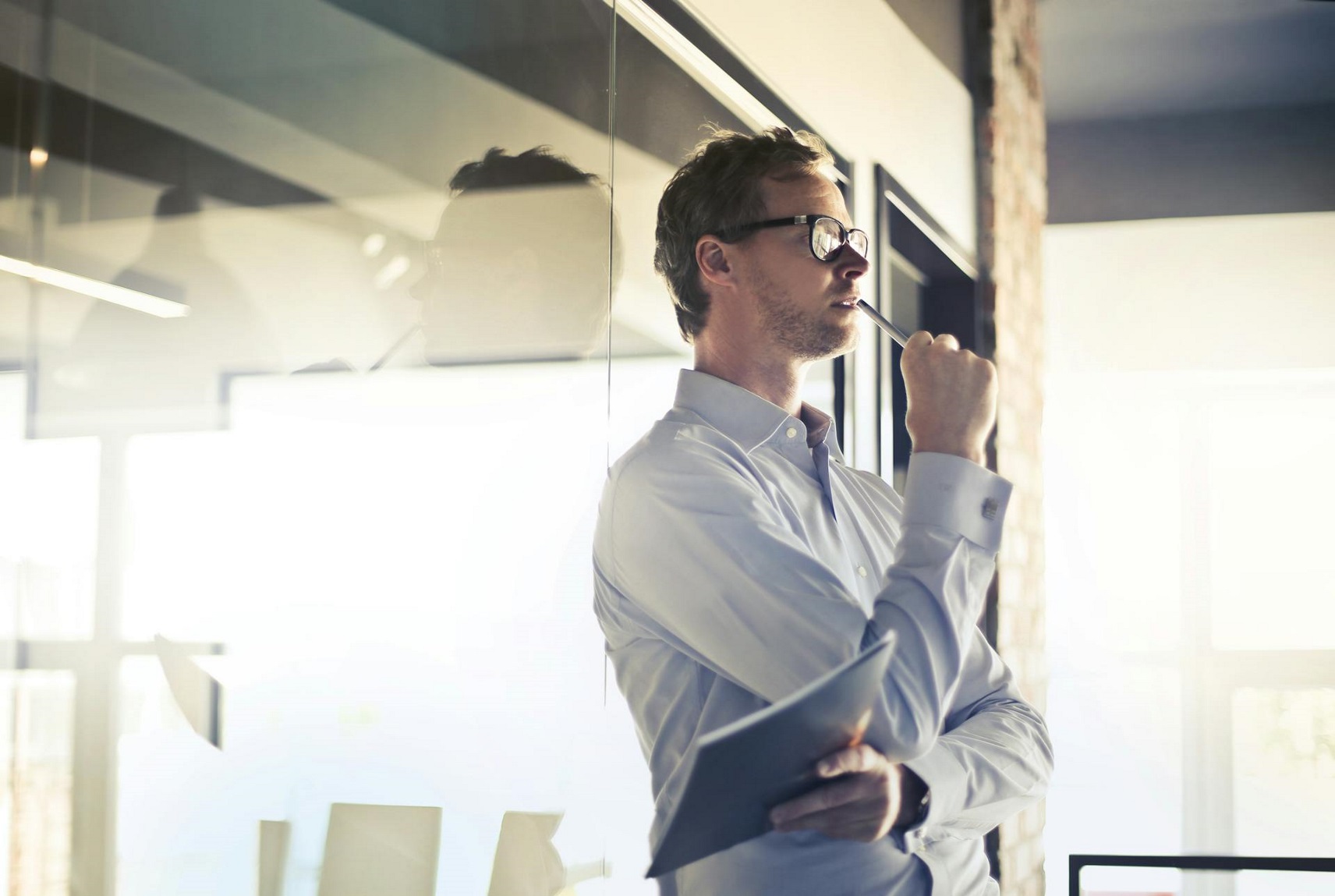 Photo by Andrea Piacquadio: https://www.pexels.com/photo/photo-of-man-in-white-dress-shirt-and-black-framed-eyeglasses-holding-a-file-thinking-3763998/